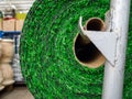 Roll of an artificial lawn. A green grass for a lawn on a counter of shop