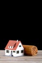 A roll of bamboo slips and a house model on the table Royalty Free Stock Photo