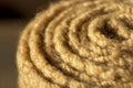 Roll of beige pattern stitch knitted woolen background