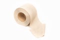 Roll of beige toilet paper on a white background