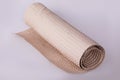 Roll of beige wrapping paper on a white background. Royalty Free Stock Photo