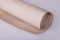 Roll of beige wrapping paper on a white background. Royalty Free Stock Photo