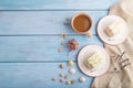 Roll biscuit cake with cream cheese and jam, cup of coffee on blue wooden, top view, copy space Royalty Free Stock Photo