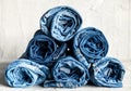 Roll blue denim jeans on gray background Royalty Free Stock Photo