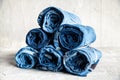 Roll blue denim jeans on gray background Royalty Free Stock Photo