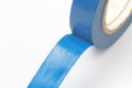 Roll of blue polymer insulating tape with a sticky layer on a white background, place for text, close-up Royalty Free Stock Photo