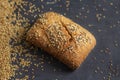 Roll bread with poppy and sesame seeds on dark background Royalty Free Stock Photo