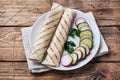 Roll with cheese and herbs. Grilled pita bread with filling. Cucumber radish salad. The concept of a healthy Breakfast Royalty Free Stock Photo