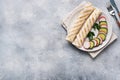 Roll with cheese and herbs. Grilled pita bread with filling. Cucumber radish salad. The concept of a healthy Breakfast. Copy space Royalty Free Stock Photo