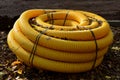 Roll, club, large yellow perforated hose, which is used in construction as a drainage water. landscape architects enjoy it on dehu Royalty Free Stock Photo