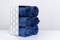 Roll denim jeans arranged in the box.