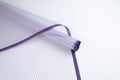 Roll of floral packaging in lilac stripes on a white background