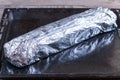 Roll in foil on a baking sheet Royalty Free Stock Photo