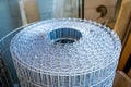 Roll of galvanized wire mesh, close-up. Universal building material for fencing Royalty Free Stock Photo