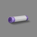 Roll of garbage bags isolated on a gray background. On the purple roll white copy space.