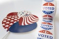Roll of I Voted Today stickers and USA balloons on white background. US election concept
