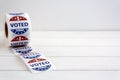 Roll of I Voted Today stickers on white wooden table with copy space. US presidential election concept