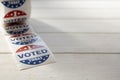 Roll of I Voted Today stickers on white wooden table with copy space. US presidential election concept