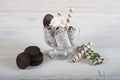 Roll of ice cream with crushed chocolate cookies. Fresh fried ice cream, ice roll on a light wooden background