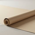 A roll of kraft paper partially unrolled on a flat surface. The paper has a light brown co Royalty Free Stock Photo