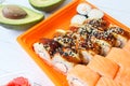 Roll made of Fresh Raw Salmon, Smoked Eel, Cream Cheese and Avocado inside. Topped with Smoked Eel or unagi Royalty Free Stock Photo