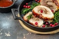 Roll of meat with various spices and berry sauce on a dark background. banner, menu, recipe place for text, top view Royalty Free Stock Photo