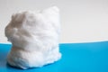 Roll of medical cotton wool on blue background Royalty Free Stock Photo