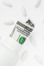 Roll of money Bills in white pill bottle with white pills. The High Cost of Health Care. Pills and US Currency in Pill Bottles Royalty Free Stock Photo