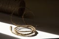 Twine Coil in Sunlight and Shadow â Rustic Craft and Minimalist Still Life Concept Royalty Free Stock Photo