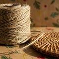 A roll of natural jute twine is placed on a surface with a decorative pattern featuring Royalty Free Stock Photo