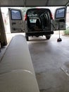 Roll of new carpet in the garage of house for replace