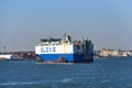 A roll-on/roll-off RoRo vehicle transport cargo ship, the Glovis Cardinal, being pushed by tugboats in New York Harbor