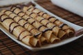 Roll pancake with chocolate on the plate