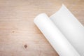 Roll of paper on wood table background. Engineer blueprint for draft work. Blank document for your design Royalty Free Stock Photo