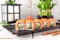 Roll Philadelphia made of Fresh Salmon, Cream Cheese, avocado and cucumber inside. Salmon sushi roll. Royalty Free Stock Photo