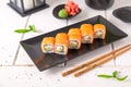 Roll Philadelphia made of Fresh Salmon, Cream Cheese, avocado and cucumber inside. Salmon sushi roll. Royalty Free Stock Photo