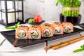 Roll Philadelphia made of Fresh Salmon, Cream Cheese, smoked eel, avocado and cucumber inside. Royalty Free Stock Photo