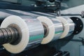 Roll of plastic packaging film on the automatic packing machine in food product factory. industrial and technology concept. Royalty Free Stock Photo