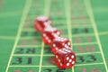 Roll of the red dice on a game table Royalty Free Stock Photo