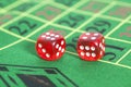 Roll of the red dice on game table Royalty Free Stock Photo