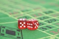 Roll of the red dice on game table in casino Royalty Free Stock Photo