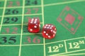 Roll of the red dice on a game table Royalty Free Stock Photo