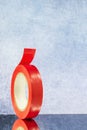 Roll red electrical tape on a grey background Royalty Free Stock Photo