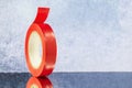 Roll red electrical tape on a grey background Royalty Free Stock Photo