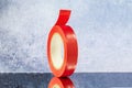 Roll red electrical tape on a grey background Royalty Free Stock Photo