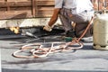 Roll roofing Installation with propane blowtorch during construc