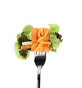 Roll salad on fork isolated on white. Royalty Free Stock Photo