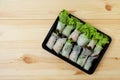 Roll salad Green oak and red oak fresh vegetables in a black plastic box on a wooden floor.Top view Royalty Free Stock Photo