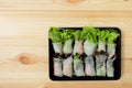 Roll salad Green oak and red oak fresh vegetables in a black plastic box on a wooden floor.Top view Royalty Free Stock Photo