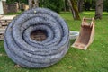 Roll stack drain drainage pipe with protective cover in city park Royalty Free Stock Photo